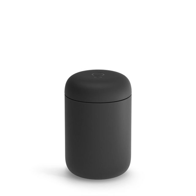 A matte black Fellow Carter Wide travel mug with its lid on
