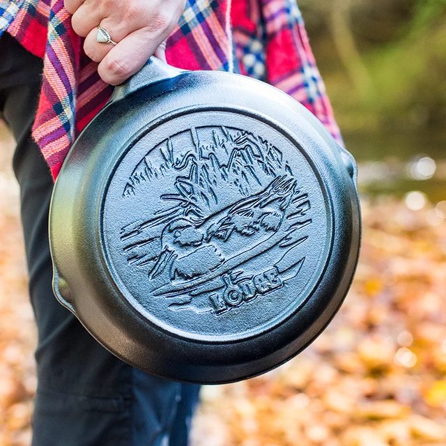 A black Lodge 8 inch cast iron skillet with a flying duck scene cast into the cooking surface
