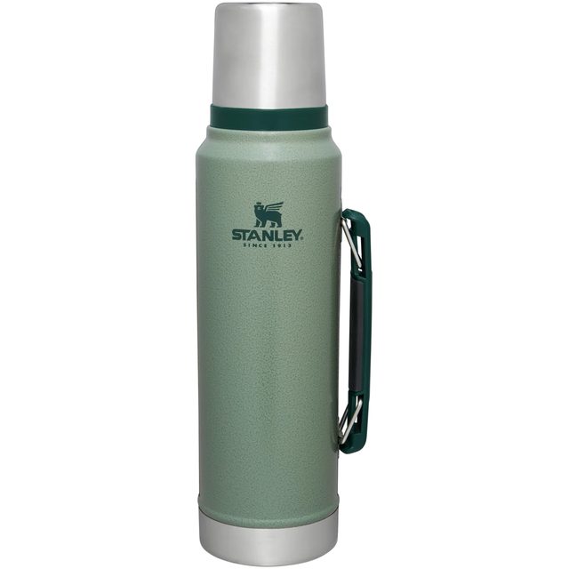 A tall hammertone green Stanley Classic vacuum bottle with a steel cup lid and a side handle