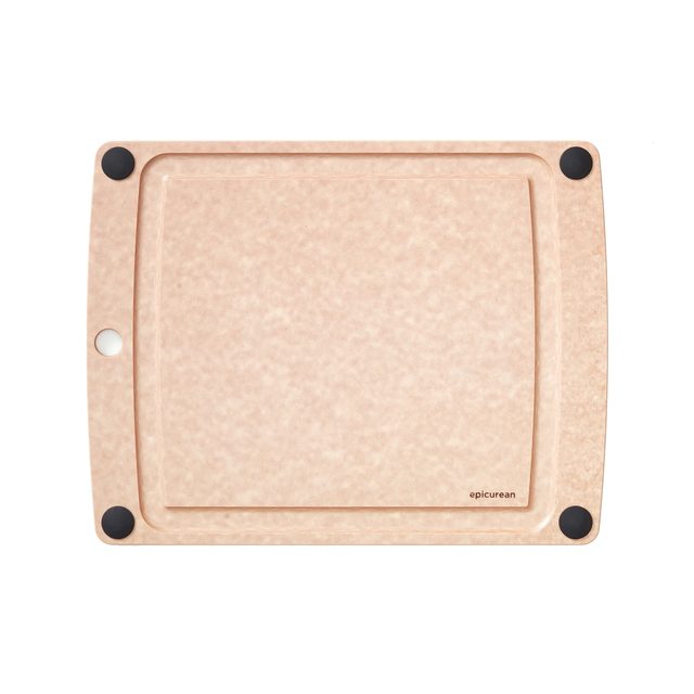 A light tan Epicurean cutting board with a juice groove and black rubber feet in its corners