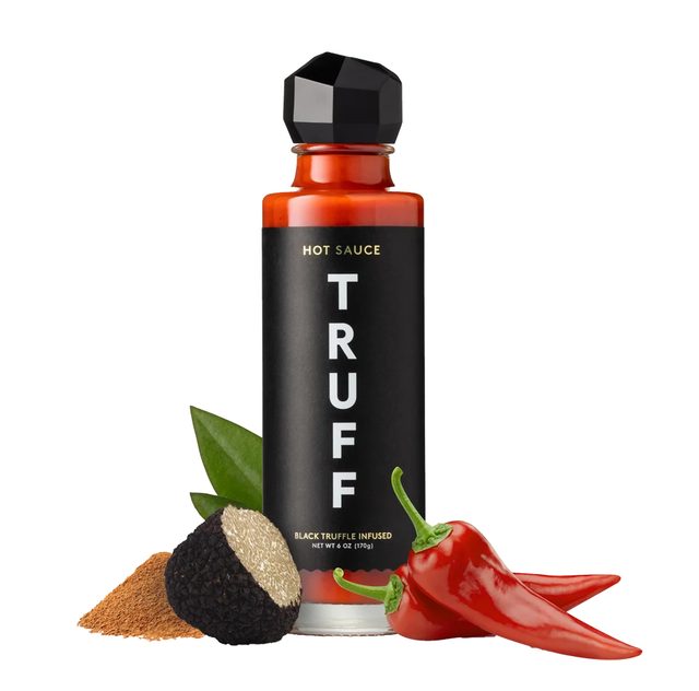 A bottle of TRUFF Original hot sauce, black glass with a faceted black cap